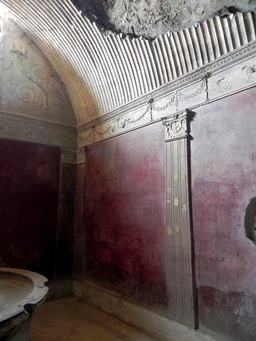 Caldarium (hot room) in the women's section with a basin, red walls